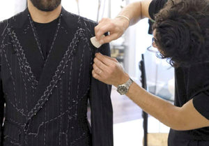 Fedro Gaudenzi altering and fitting bespoke suit jacket on man 